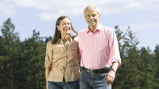Senioren-Ehepaar spaziert am Waldrand